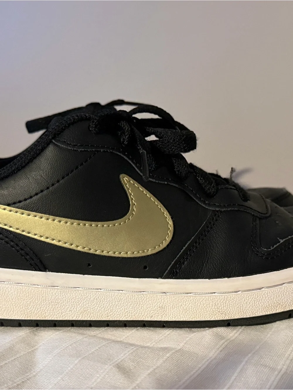 Nike Kids Black Sneakers with Gold Swoosh